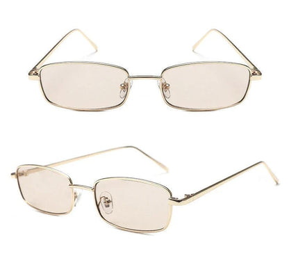 Slim rectangular eyeglasses with gold metal frame and tinted lenses on white background