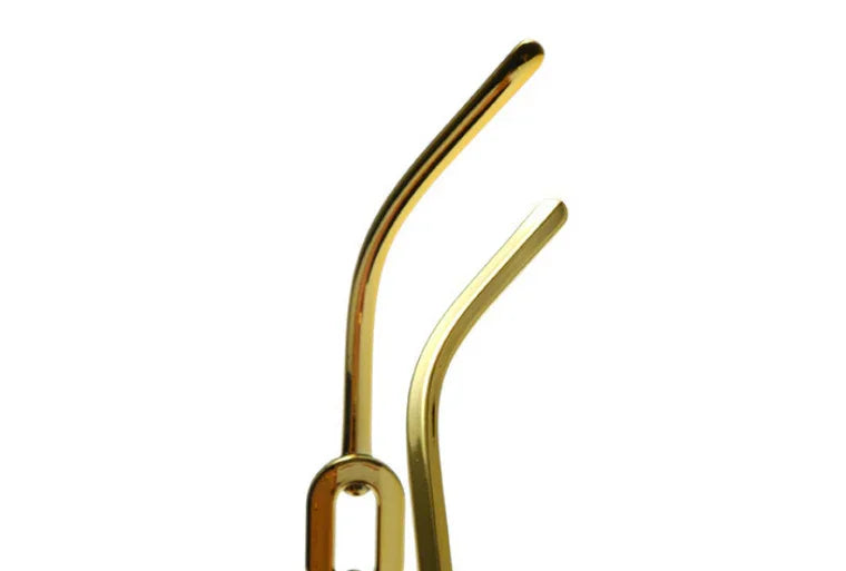 Close-up of two golden metal straws with curved tips on a white background