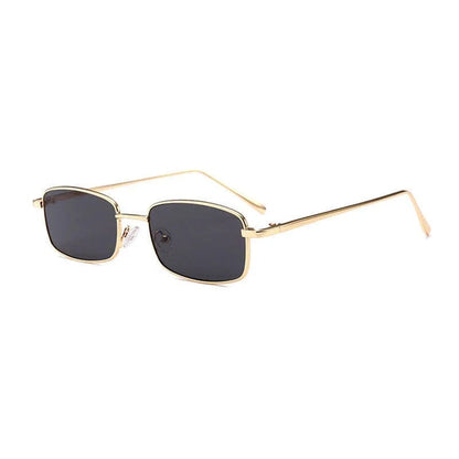 Rectangular sunglasses with gold metal frame and dark tinted lenses on white background
