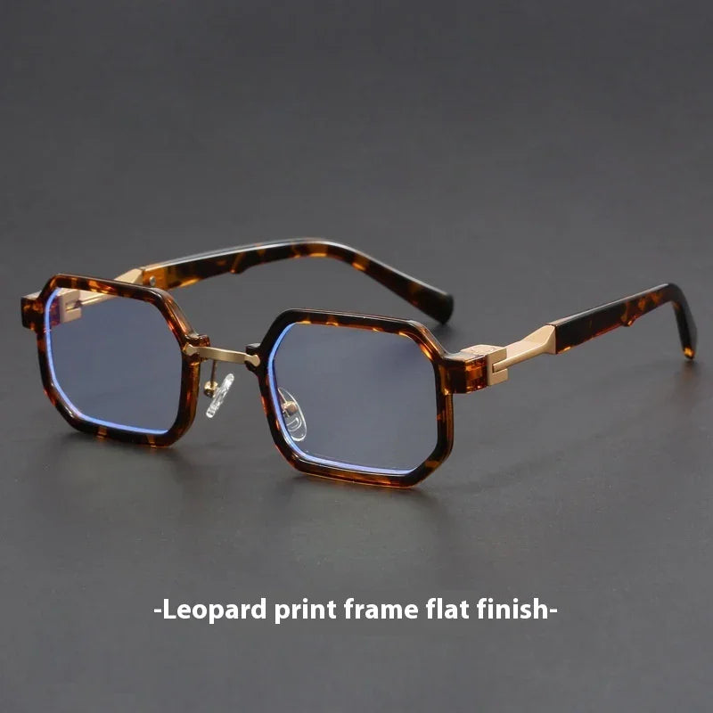 Tortoiseshell octagonal eyeglasses with blue lenses and gold metal accents on a dark surface