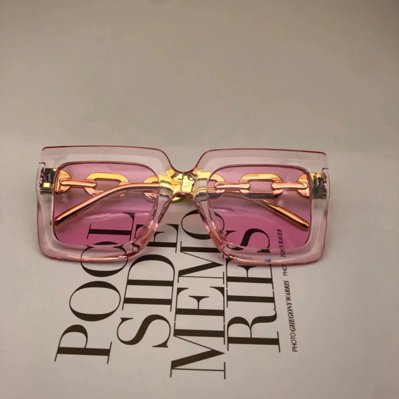 Pink tinted square sunglasses with gold chain detail, stylish fashion eyewear for women