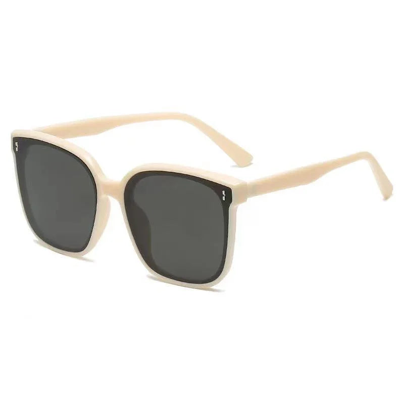 Beige square frame sunglasses with dark tinted lenses on white background