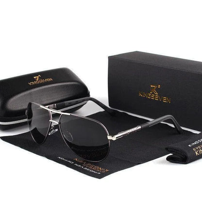 black and silver polarized aviator sunglasses with black protective case and branded box on black cloth