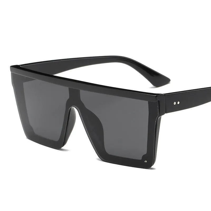 Oversized black square fashion sunglasses with dark lenses and thick frames