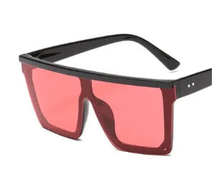 Oversized square sunglasses with black frame and pink tinted lenses on white background