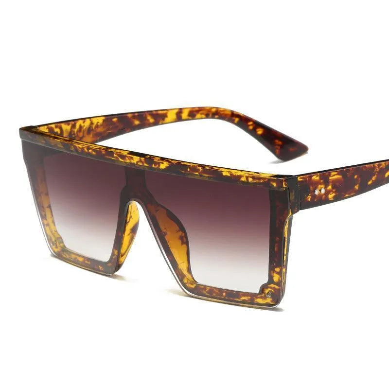 Oversized square sunglasses with tortoiseshell frames and gradient brown lenses on a white background