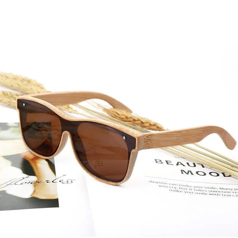brown polarized sunglasses with bamboo frame resting on open magazine with wheat stalks
