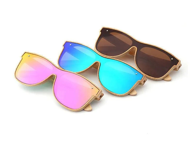 Three bamboo frame sunglasses with mirrored pink, blue, and brown lenses on white background