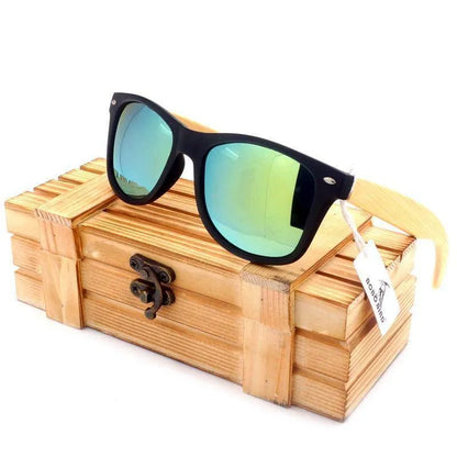 Wooden sunglasses with blue-green mirrored lenses resting on a rustic wooden box with metal clasp