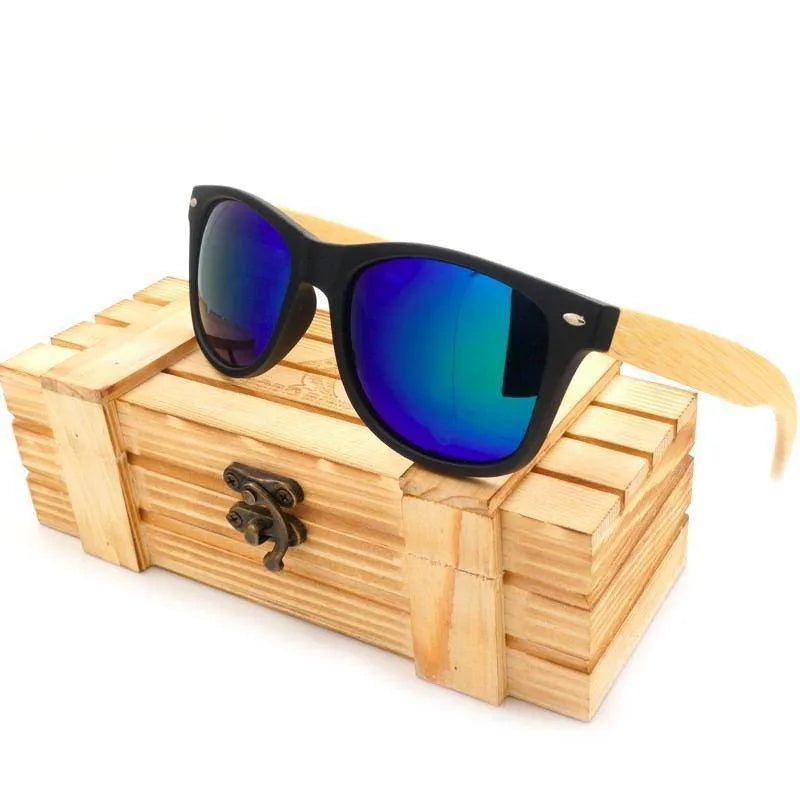 Black frame sunglasses with blue mirrored lenses and light wooden temples on wooden box