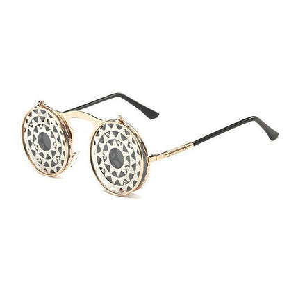Round steampunk sunglasses with gold frames and black spiral patterned lenses on a white background