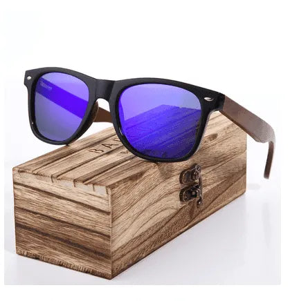 Glossy black frame sunglasses with blue polarized lenses and wooden arms resting on wooden storage box