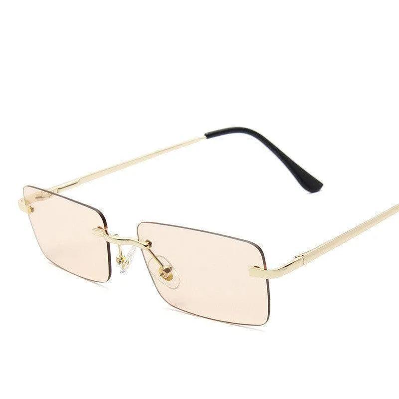 Gold rimless rectangular sunglasses with tinted lenses and black temple tips