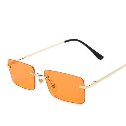 Rimless women's square sunglasses with orange lenses and gold temples on white background