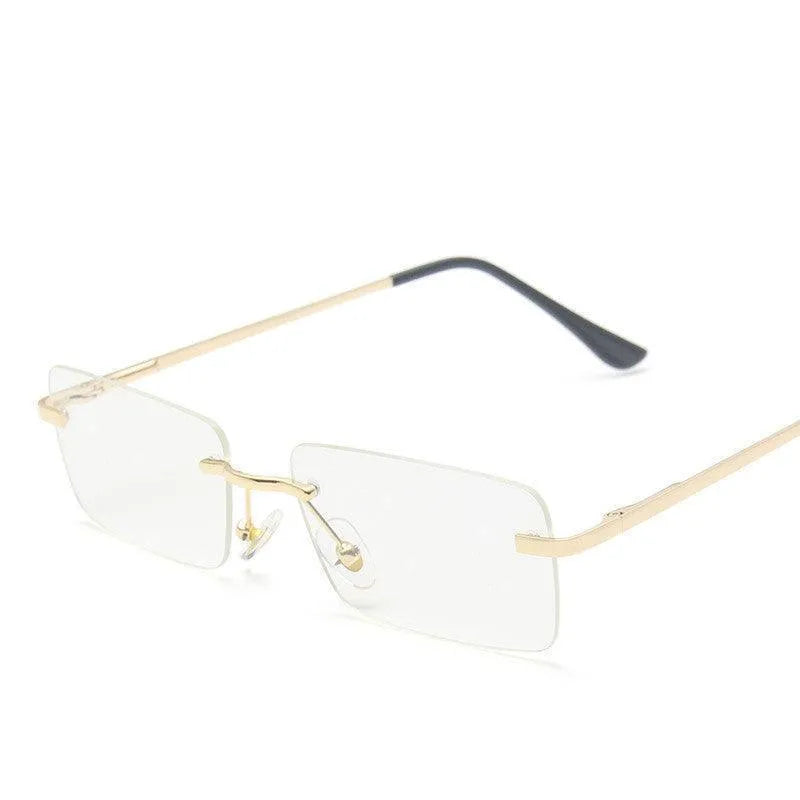 rimless rectangular eyeglasses with gold metal frame and black temple tips on white background