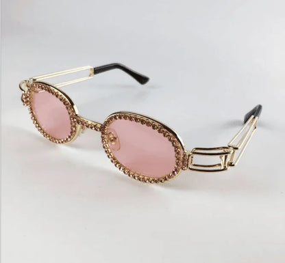 Vintage small oval sunglasses with pink tinted lenses and gold beaded frame